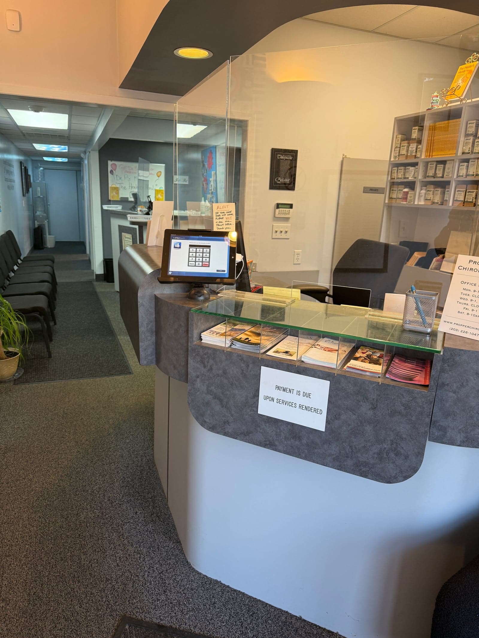 The front desk and waiting area inside Propper Chiropractic's Westport office